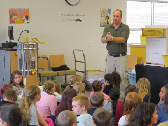 Mang gives fourth graders a beekeeping demo in the Delaware Valley Elementary School library.