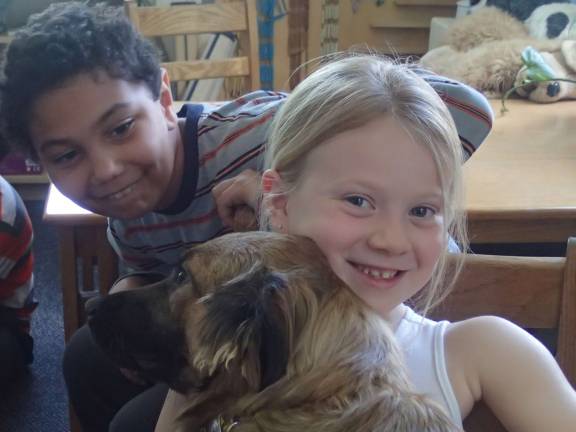 Second graders Jayden Benoski-Bowens and Baitelyn Rich with Ailish, rescued from a high kill shelter. Photo by Becca Tucker