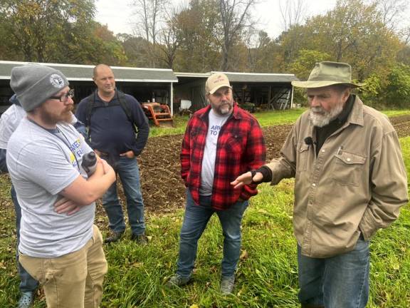 Stewart gives a farm tour to the group of veterans, who came from the Marines, Army, Navy and Air Force.