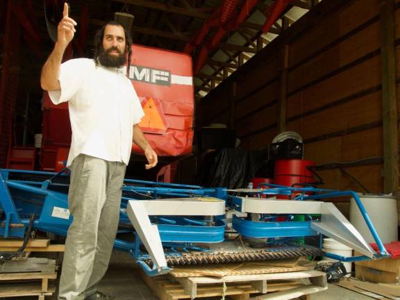 Yisroel Bass with harvesting equipment.