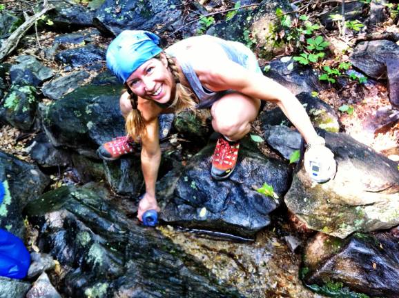 Heskett filling up a water bottle in Virginia after her first-ever overnight in the woods.
