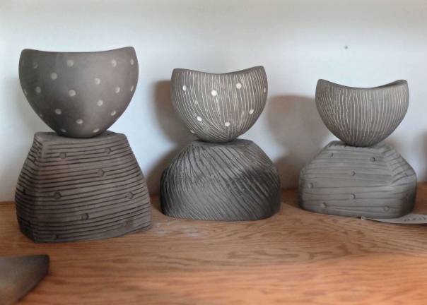 Smoke fired pinch pots with textured surface and underglaze