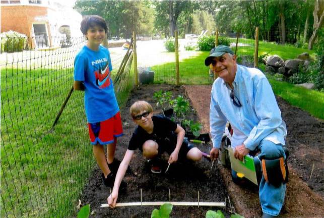 Mike Levy with his grandsons in the ‘hunger garden’ they built together in the kids’ yard in Bedford, NY.