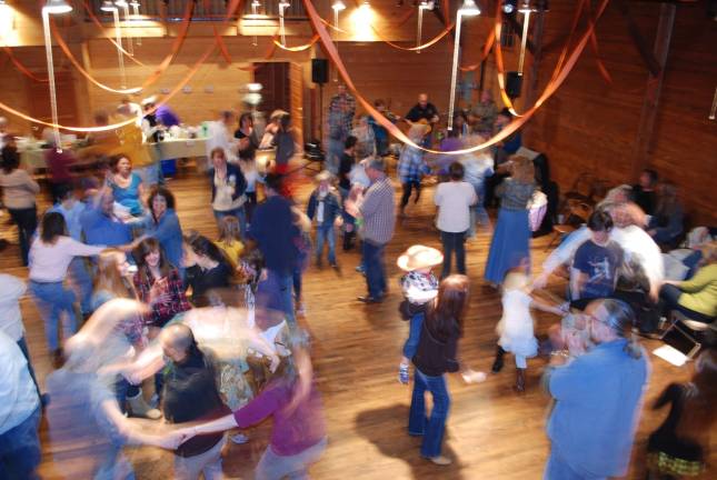 Square dancers &quot;put the birdie in the cage&quot; at Wisner Barn, to the calls of Joe Miedema.