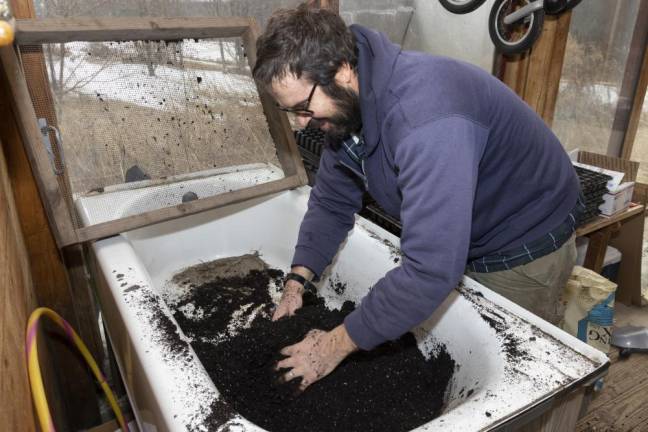 Will Summers mixes fresh soil tp plant onion seeds at Freedom Farm Community in Otisville NY on March 1, 2022. ROBERT G BREESE FOR STRAUS NEWS