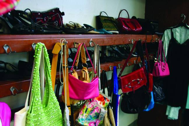 Purses and shoes are displayed where children's jackets and lunches were once stored at the former Pine Island Elementary School. Photo by Raheli Harper.