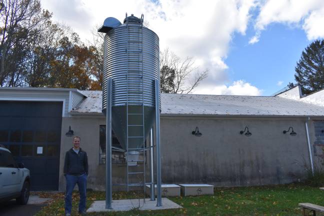 Lenny Bussanich with the silo, which can hold 12,000 pounds of grain. ‘We haven’t used it yet. We thought it was going to be used for farms in the area but the yields just weren’t high enough,’ he said of the $7,000 purchase.