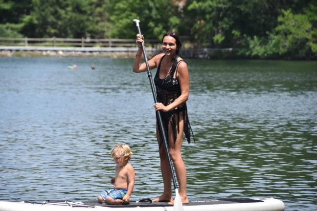 Kate Assaraf with her younger son, Des, on the lake where they live in Sparta, NJ. A surfer and long distance runner, Assaraf designed NOAP for outdoor athletes and “people who love the water, wherever they are.”