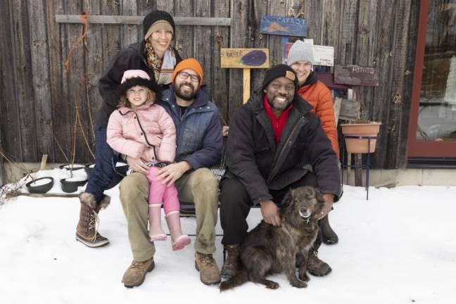 The two families that make up the permanent contingent of the Freedom Farm community. From left Sarah Henkel, Leland Henkel, Will Summers, Edgar Hayes, Ann Rader with dog Teo at Freedom Farm Community in Otisville NY on March 1, 2022.