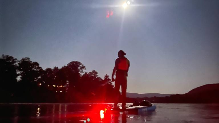 Joe Gara paddleboarding the Delaware on his first Full Moon Float in August.
