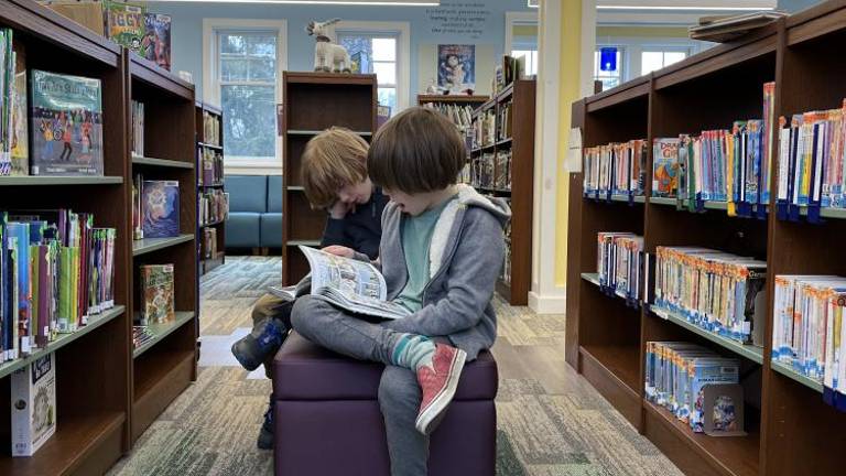 The writer’s kids reading the old fashioned way at the Goshen Public Library.