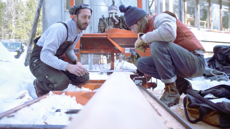 Sam Merrett and Brett Miller milling up salvage lumber to build the main boom in 2017.