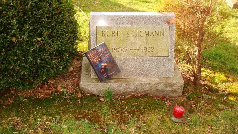 Seligmann’s book, <i>The History of Magic and the Occult</i>, originally published in 1948, at the artist’s grave in Sugar Loaf, NY.