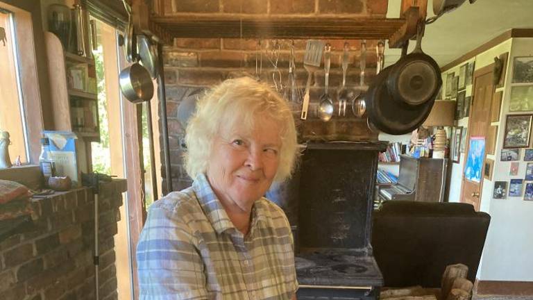 Julie Rawson in her farm kitchen. September finds Rawson preserving tulsi, husk cherries, chard, soybeans, broccoli, kale, cucumber pickles, grape juice, applesauce, canned tomatoes and cabbage. October? Garlic for garlic powder, cauliflower, collards, celery, parsley, hemp, winter squash, apple cider and pears.